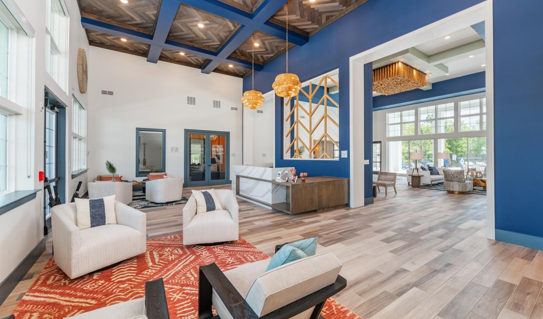 Settle into comfort at The Reserve at Venice a living room with a large blue and white ceiling