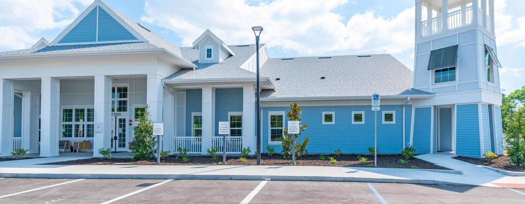 a large white building with a parking lot in front of it