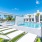a pool with lounge chairs and a building in the background