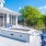 a deck with chairs and a pool